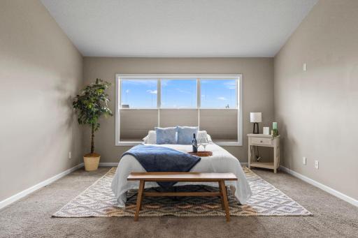 Primary bedroom with custom Hunter Douglas blinds