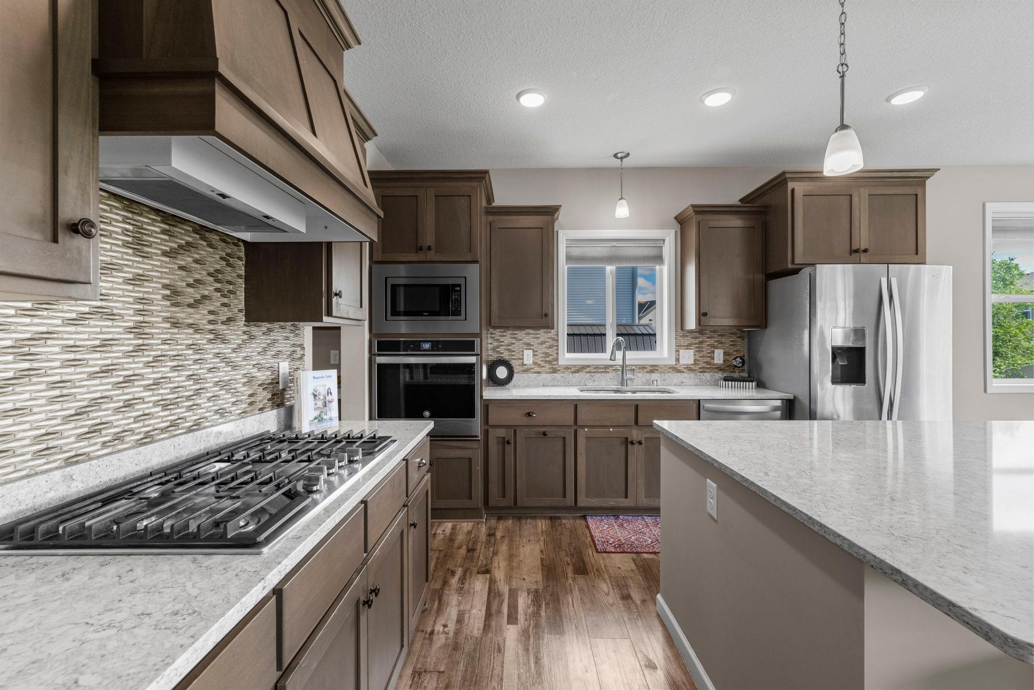 Gourmet Kitchen with window. The whole house features custom Hunter Douglas Blinds