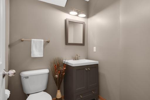Main floor half bath has been nicely updated with new vanity and lighting