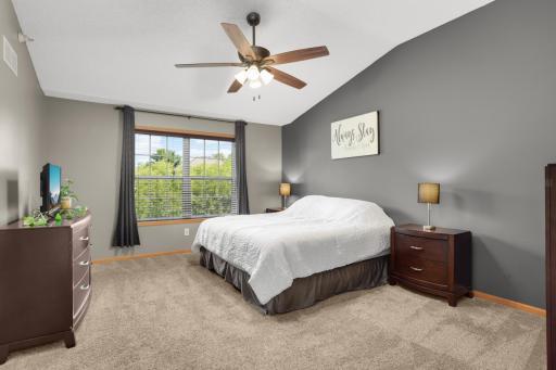 Moving upstairs, this oversized primary bedroom offers great. natural light, walk-in closet, and ceiling fan.