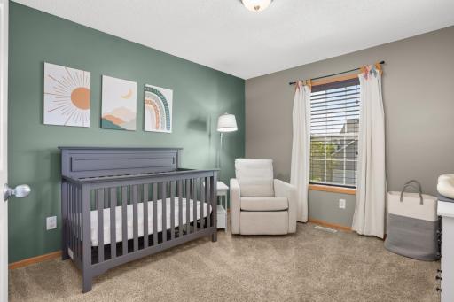 Second upper level bedroom features walk-in closet and accent wall