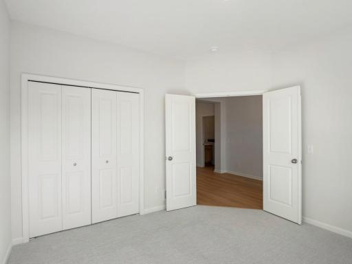 Bedroom with double doors at the front of the home - or use as a den/office!