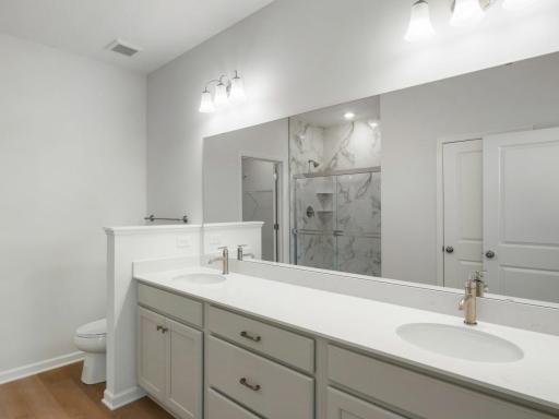 The owner's bath is huge and features dual sinks, linen closet, tiled shower and walk-in closet!