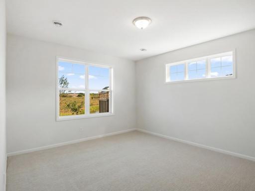 Owner's bedroom is spacious and has views of the pond!