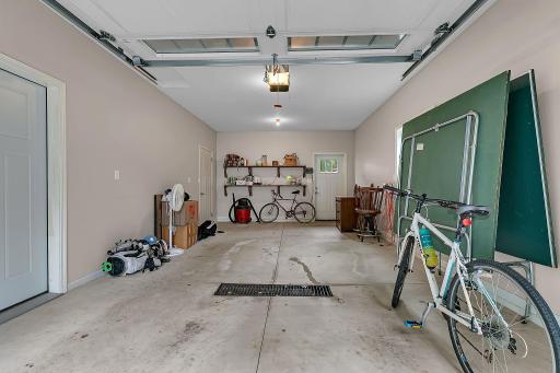 Garage with in-floor heat and storage room.