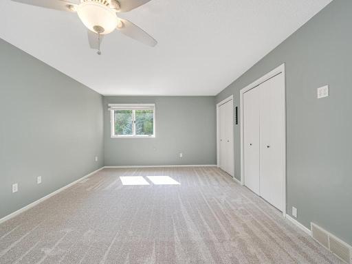 Primary suite has new carpet and natural light from both sides