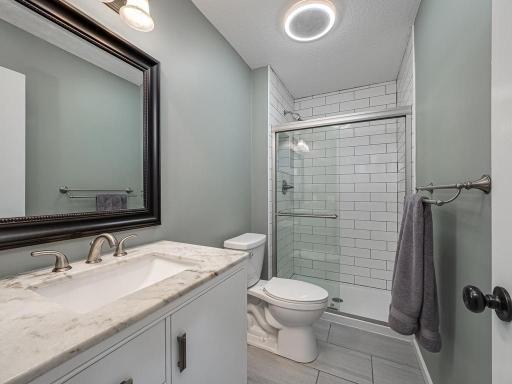3/4 Primary bath with beautifully tiled shower, Light/fan/speaker, Tile flooring