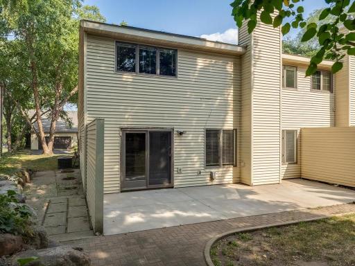 Walk out to a concrete patio, Wall separating you and the neighbors