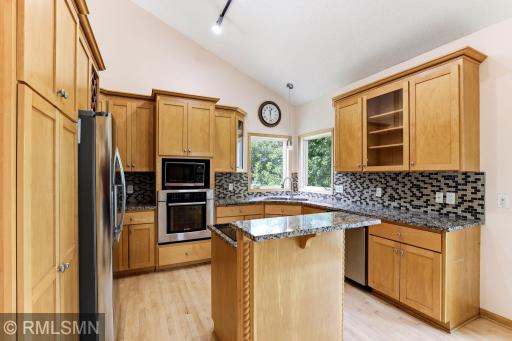 The Kitchen has hard surface counters and an Island cooktop.