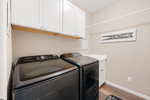 Laundry room with utility sink and hanging rack