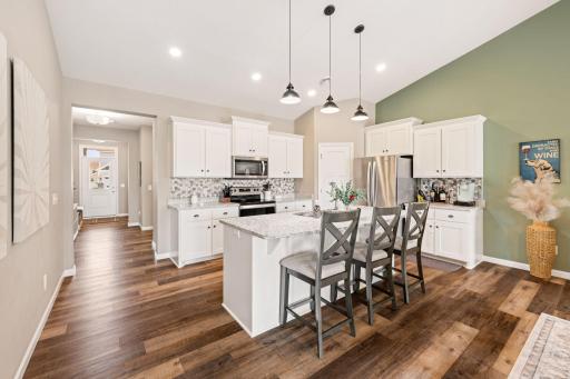 Gourmet kitchen with granite countertops, tiled backsplash, stainless steel appliances