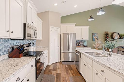Conveniently located corner pantry with custom shelving
