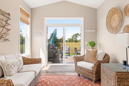 Sun room walks out to an extended patio that overlooks the corner of the 5th green