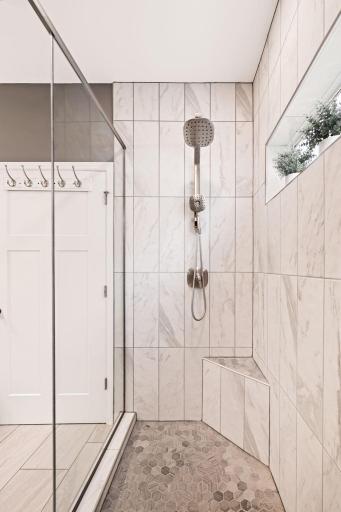 The WOW factor! Floor to ceiling tile and glass shower door