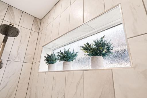 Peep this window cut-out that allows natural light into the bathroom