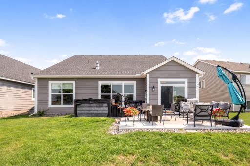Oasis in the backyard with an extended patio slab and hot tub