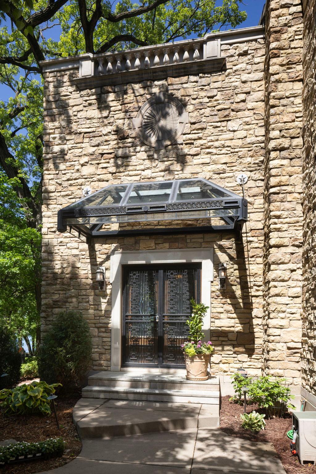 Glass canopied French door access from terrace to sunroom
