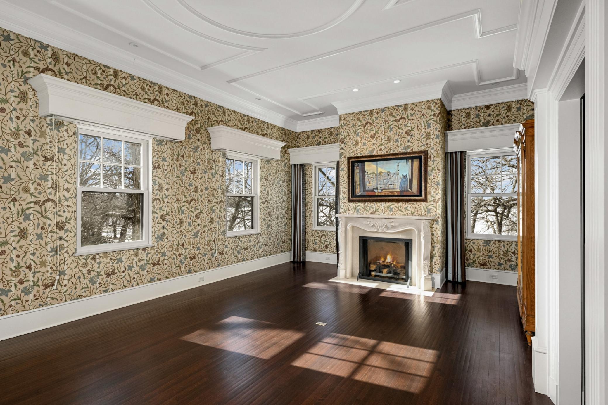 Primary bedroom with fireplace and lake views