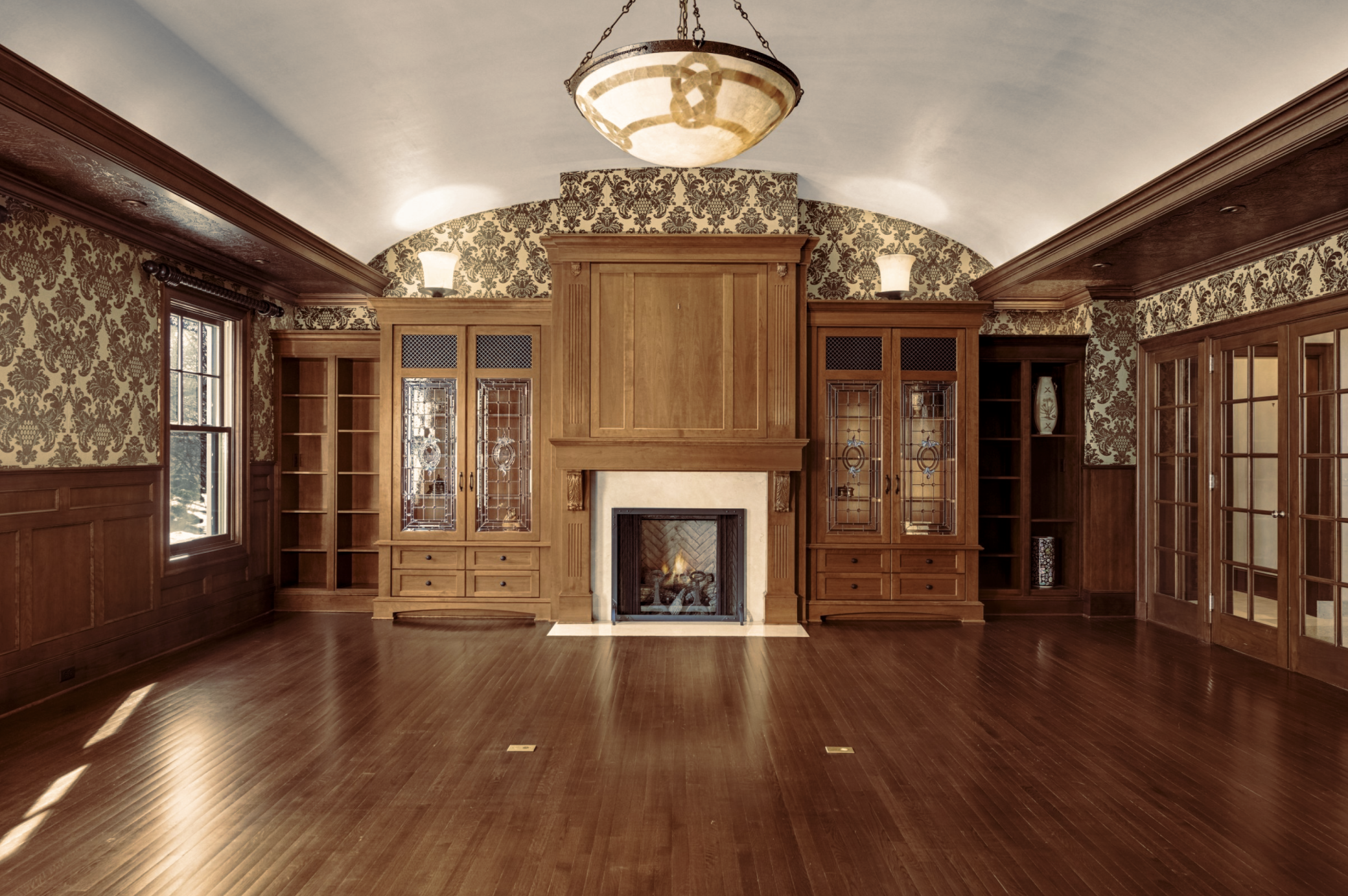 Fireplace wall in barrel vaulted mezzanine level family room