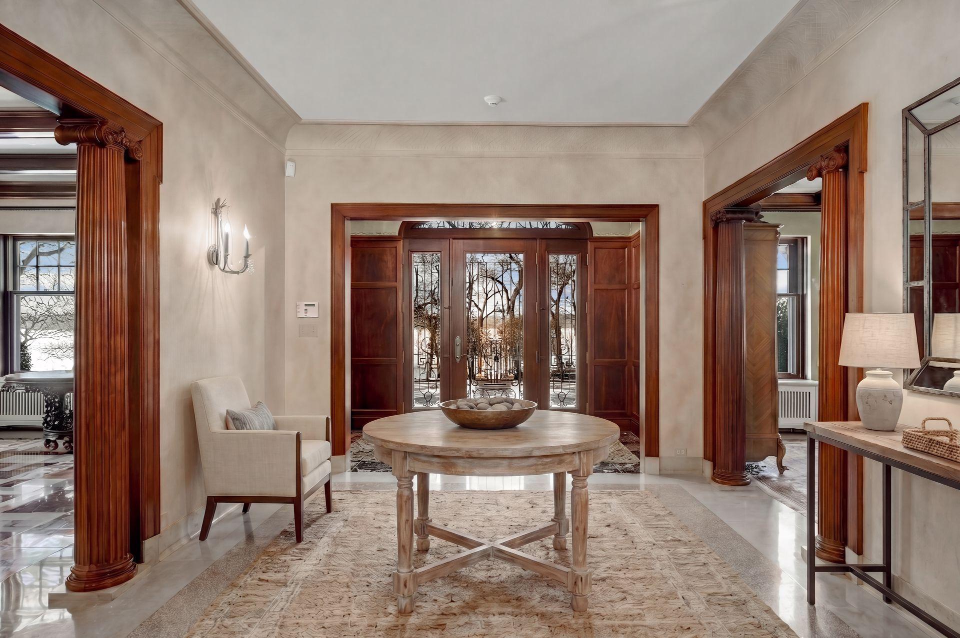 Gracious entry hall with terrazzo floors, natural woodwork, leaded entry doors (virtually staged)