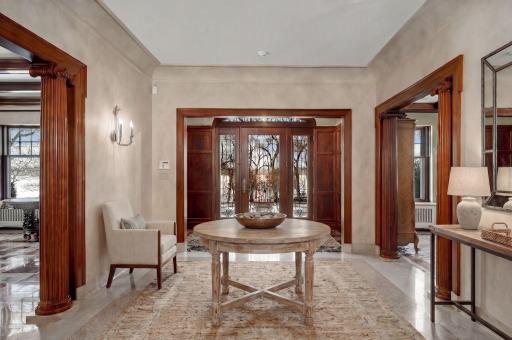 Gracious entry hall with terrazzo floors, natural woodwork, leaded entry doors (virtually staged)
