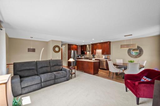 Open living area includes a high-end kitchen with island and stainless steel appliances.