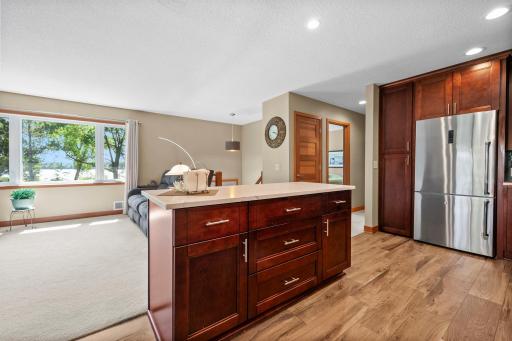 Open kitchen concept with large island, tons of cabinets and porcelain tile floors.