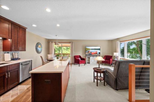 Open kitchen, dining and living room area with view out to the deck.