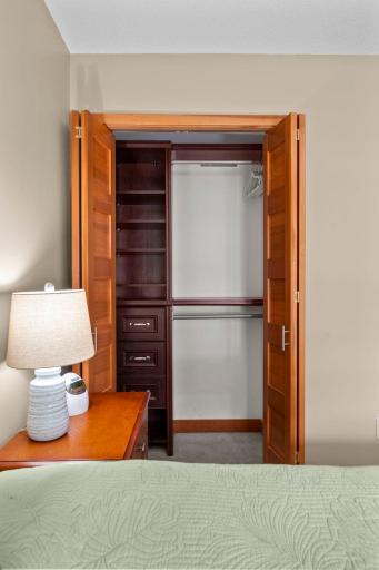 Beautiful 5-panel closet doors open to show off the cherry closet organizers.