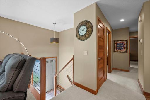 Top of the stairs - classy wood railings and natural wood steps.