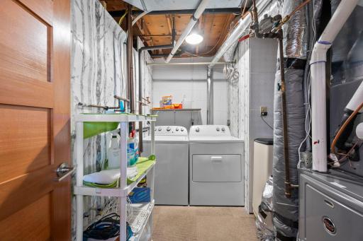 Dedicated laundry/utility room. Note the gorgeous 5-panel door on the left. These doors are throughout the house! Water heater is 2 years old; water softener stays with home.