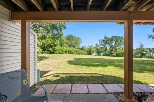We are on the covered patio enjoying the beautiful day and gorgeous lake views across the large, shared green space between the house and the lake.