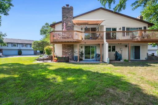 Home is on the left. View showcases the yard, big deck and covered patio.