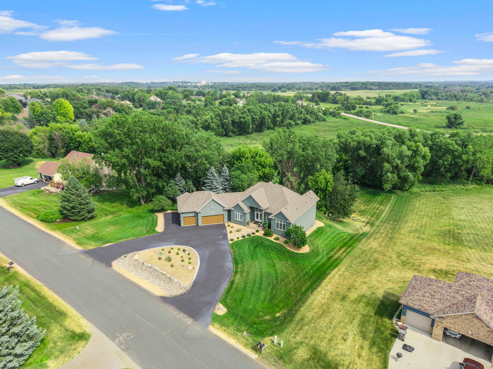 Full circular drive way with a private backyard