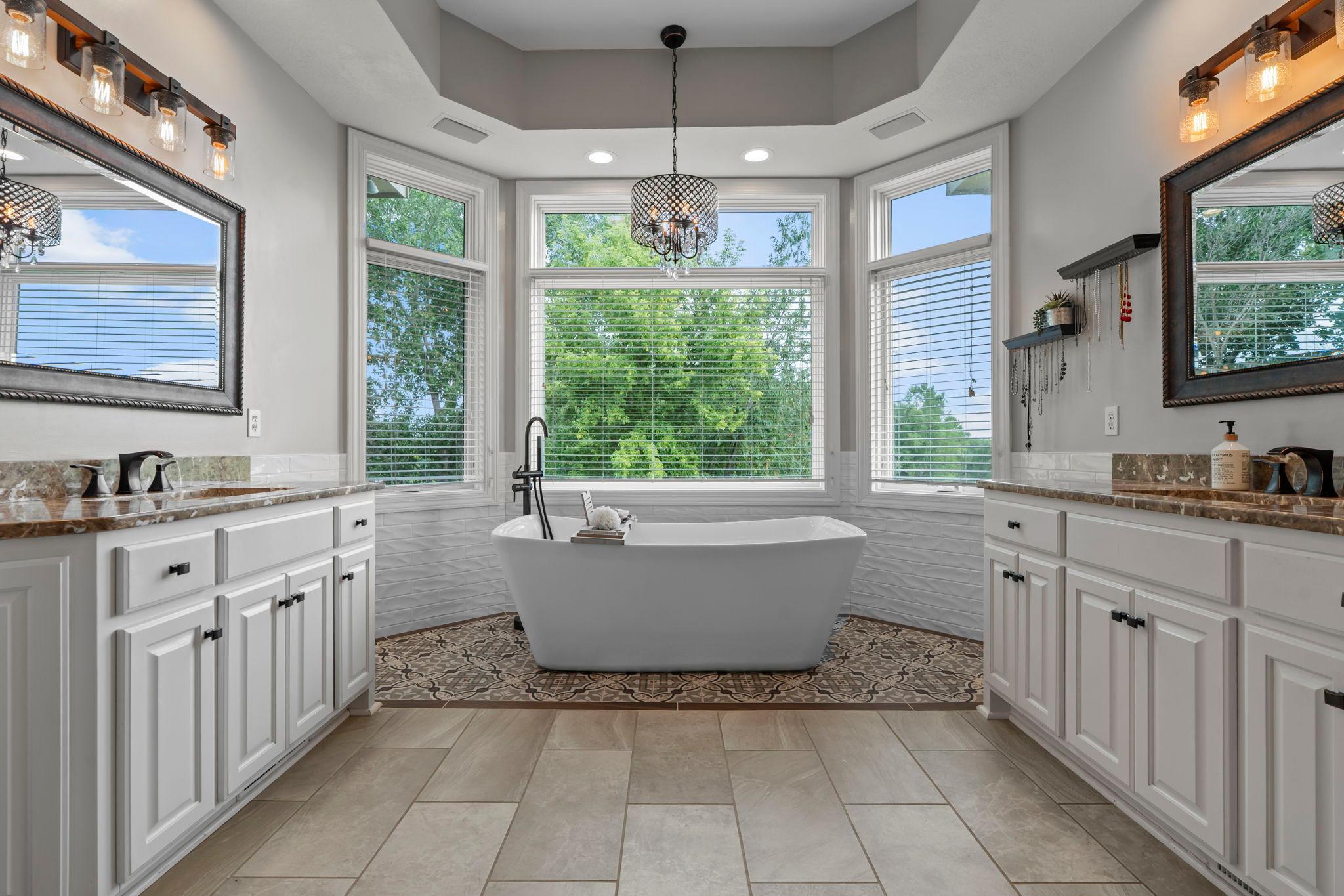 Tastefully updated primary bathroom with separate dual vanities