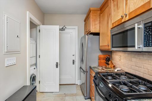 Stackable in unit laundry located in Kitchen closet