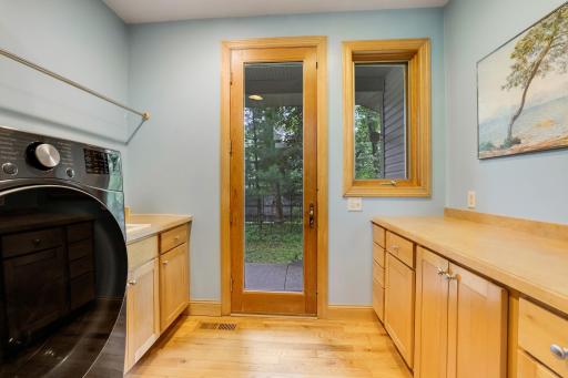 Separate laundry room with door to deck