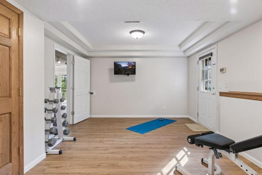 Lower level exercise/ flex room that also has a convenient walkout to the side yard, (the door on the left is to the Utility Room)