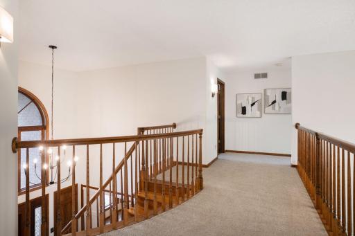 Loads of light throughout the upper level. The seller has just updated all of the paint, sconces and chandeliers (an addl one is the the right that completes the vaulted living room)