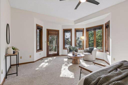 Main floor Bedroom connects to the 3 season porch making it a wonderful spacious guest option. This room could possibly be expanded into a 2nd Primary Suite by connecting the upper plumbing and taking a portion of the Den - consult a professional.