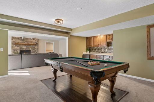 Game area with wet bar (not shown - the finished storage room is just on the other side of this room). The Pool Table can be included in the sale
