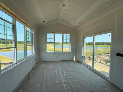 The morning room takes full advantage of the gorgeous pond views. We've included a deck on this home as well!