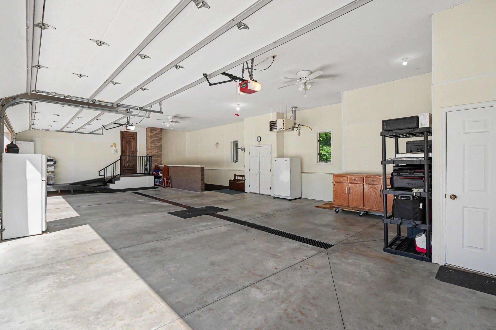 One of two oversized heated garages offers impressive space for vehicles, toys, storage and hobbies. Direct access to the lower level adds another layer of convenience and functionality. Both upper lofts are ready for your personal touches.