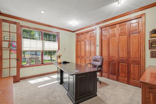 A bright main-level office offers a comfortable workspace with natural light, French doors and abundant closet storage. Its flexible layout also allows it to serve as an additional main-level bedroom, guest room or private retreat.