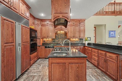 Designed for serious cooks with the 5 burner Wolf range. This spacious kitchen offers abundant cabinetry, generous prep space and a well-appointed center island. The open layout keeps everything connected while still providing plenty of room to work.