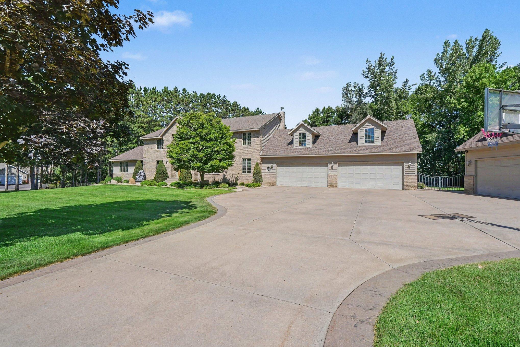 A sweeping driveway leads to this impressive custom home and its remarkable 8-car heated garage capacity, offering exceptional space for vehicles, recreational toys and hobbies. Beautiful landscaping, mature trees and the expansive setting.