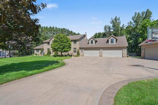 A sweeping driveway leads to this impressive custom home and its remarkable 8-car heated garage capacity, offering exceptional space for vehicles, recreational toys and hobbies. Beautiful landscaping, mature trees and the expansive setting.