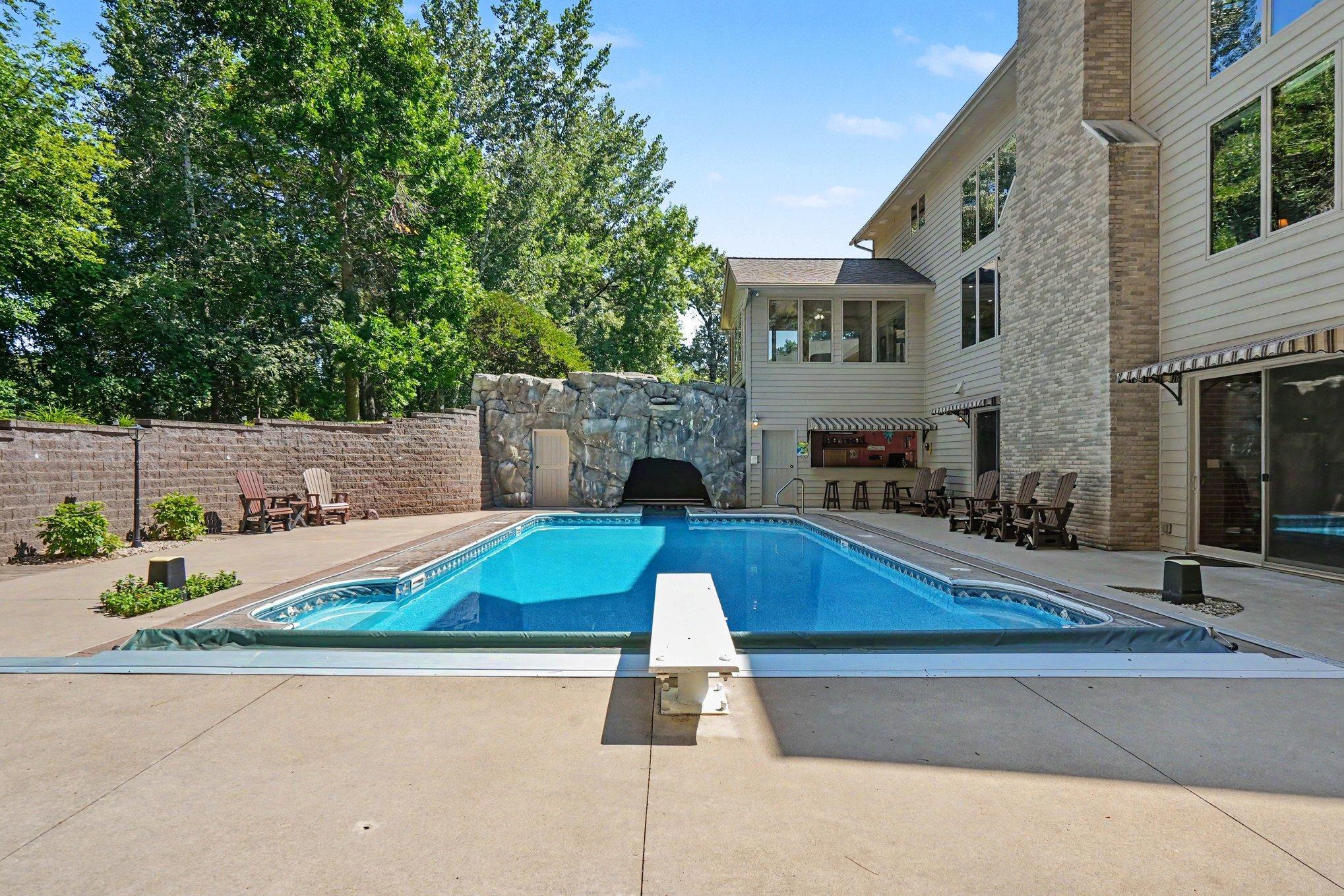 Dive right in and make this private backyard retreat your own, complete with an in-ground pool, expansive patio and rock grotto. Summer memories are waiting—make this incredible home yours today!