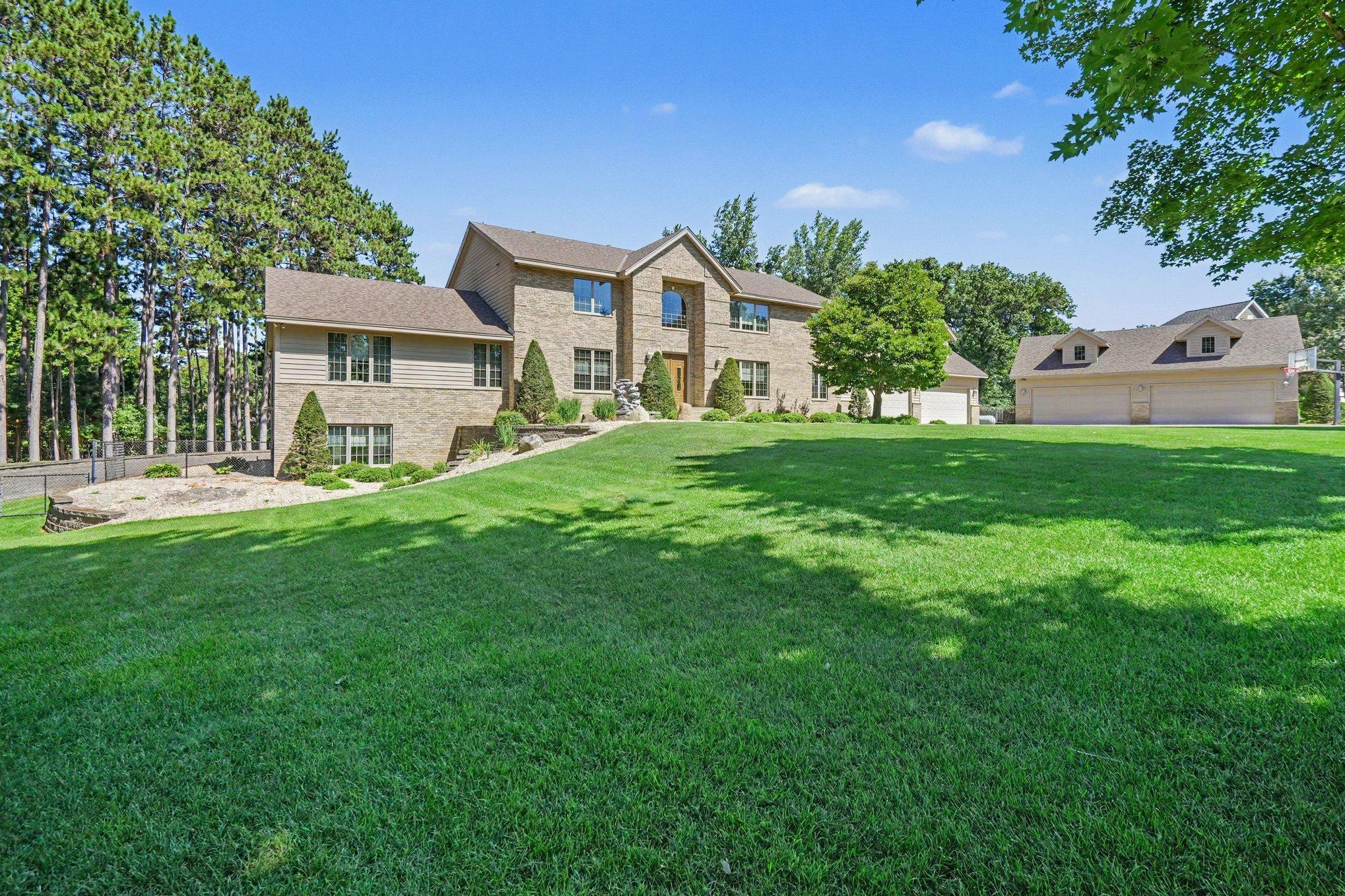 The walkout lower level feels bright and connected to the outdoors with full-size windows and direct exterior access—no small egress windows here. Natural light and easy walkouts make the lower level feel like true living space, not a basement.