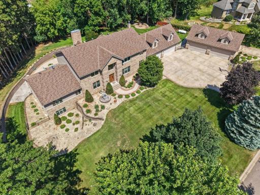 A stunning first impression of this expansive custom home, beautifully positioned on 1.5 acres and surrounded by mature trees, lush landscaping and exceptional privacy.